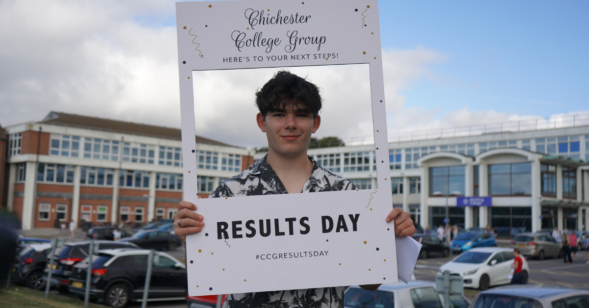 One of our students who received their results holding a photo frame