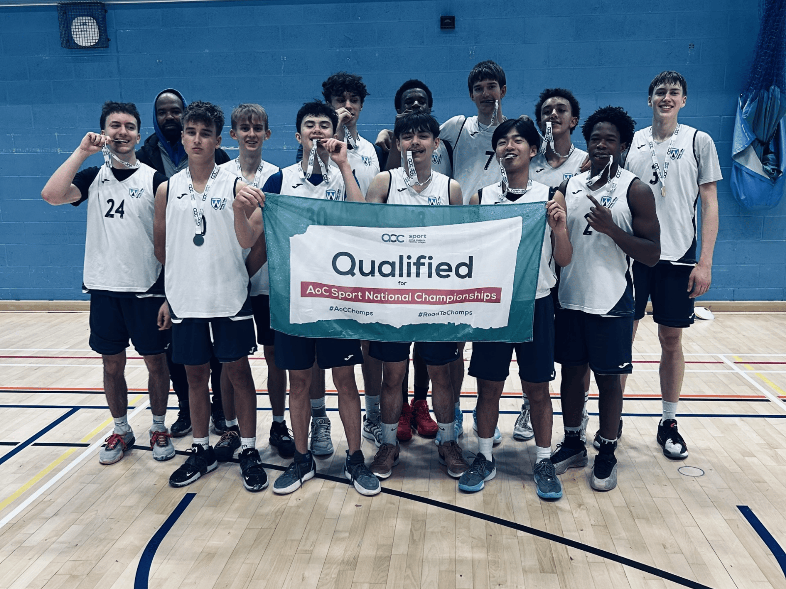 Our winning team holding a banner after they qualified for the AOC finals
