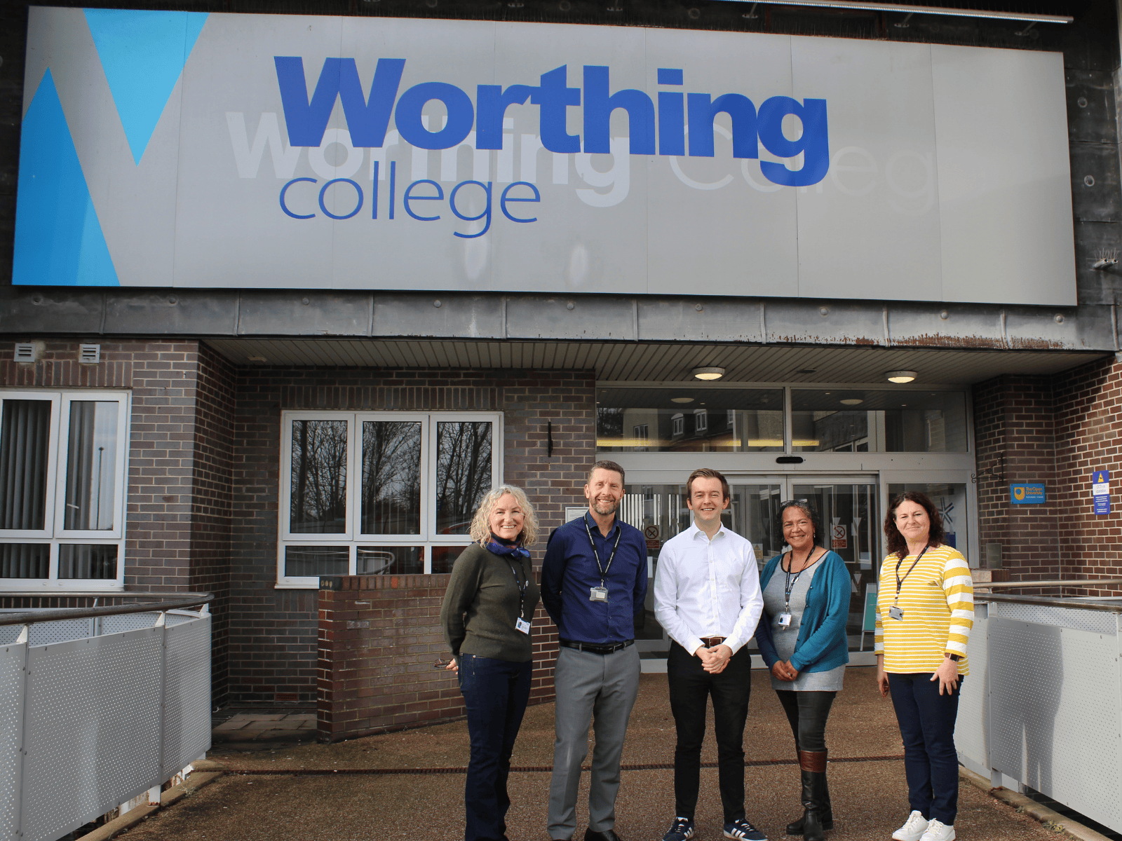 Tom Rutland stood outside Worthing College with our Principal, Vice Principal and college staff
